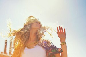 Blonde woman with long hair enjoying the sun on a summer's day